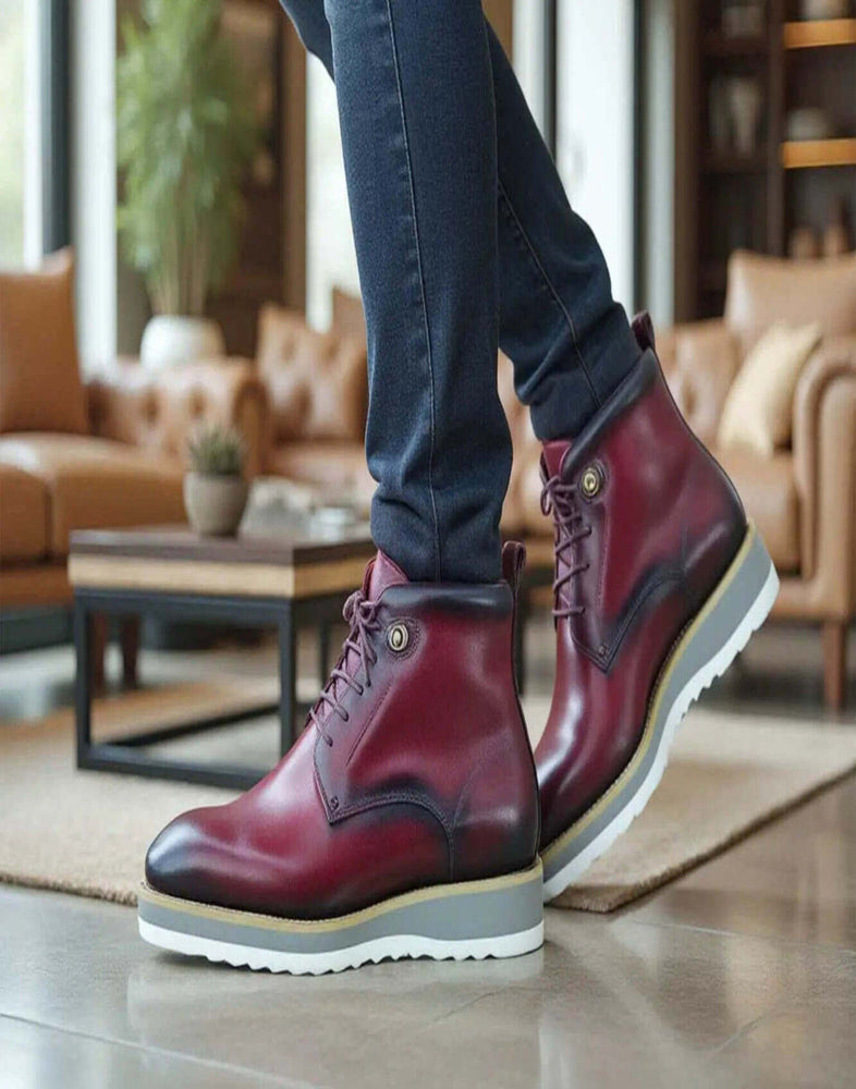 Maroon leather boots with man sitting on couch