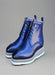 Glossy blue leather boots with white sole