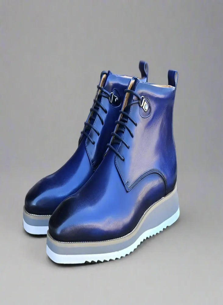 Glossy blue leather boots with white sole