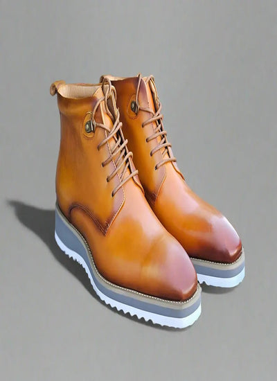 Light brown leather boots with white sole