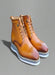 Light brown leather boots with white sole