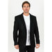 Man wearing a black blazer over a white shirt on a white background